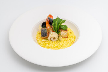 Seafood risotto, risotto alla pescatora, served on a white porcelain plate