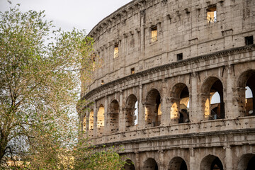 Fototapeta premium Arches archictecture of Colosseum (Colosseo) exterior with clouds and sky. Rome, Italy.