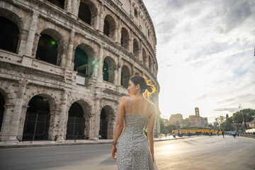 Woman enjoy view of Colosseum (Colosseo) exterior Rome, Italy.
