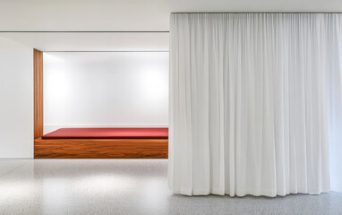 Minimalist indoor space featuring a wooden platform and white curtains in a well-lit environment