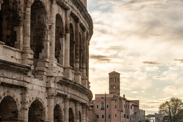 Arches archictecture of Colosseum (Colosseo) exterior with clouds and sky. Rome, Italy.