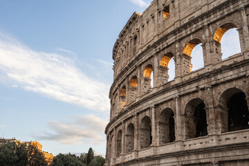 Arches archictecture of Colosseum (Colosseo) exterior with clouds and sky. Rome, Italy.