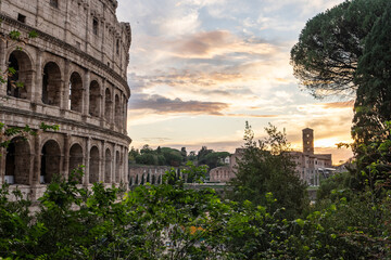 Fototapeta premium Arches archictecture of Colosseum (Colosseo) exterior with clouds and sky. Rome, Italy.