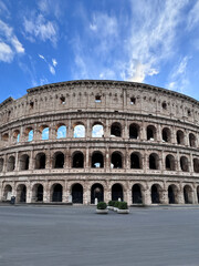 Obraz premium Arches archictecture of Colosseum (Colosseo) exterior with clouds and sky. Rome, Italy.
