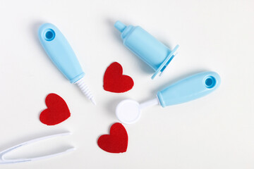 dentist tools for children isolated on white with red heart shapes. celebrate valentine day. playset for kids, imaginative learning montessori check or oral care tool.