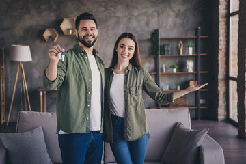 Photo of charming cheerful married guy lady wear casual shirts inviting enter new apartment indoors...