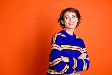 Photo of cute lovely woman crossed arms wear trendy winter sweater empty space isolated on orange...