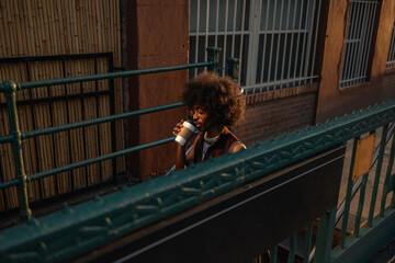 Young stylish man drinking coffee outside in New York City
