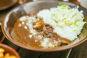 beef curry served on a plate.