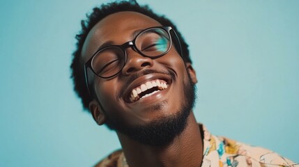 Fototapeta premium Smiling man in glasses enjoys sunny day with clear blue sky background