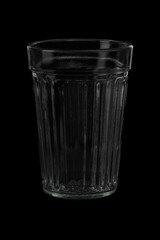 empty tall transparent faceted glass  on black background