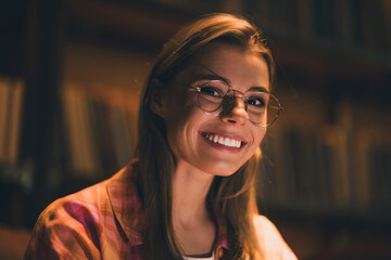 Photo of lovely young blonde lady cheerful toothy smile dressed plaid shirt study dark comfortable...
