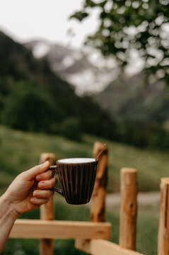 Cozy Moment in Alpine Nature with Hot Beverage