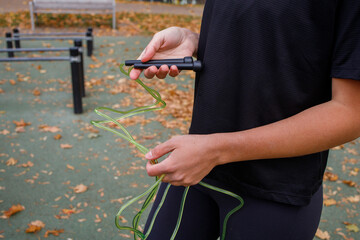 Girl keeping the jumping rope in hands before training