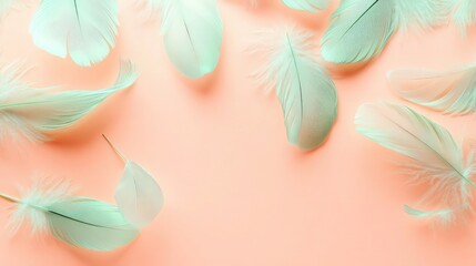 A collection of feathers in pastel mint tones scattered gently over a warm pastel peach background, creating a tranquil and balanced composition with open space.