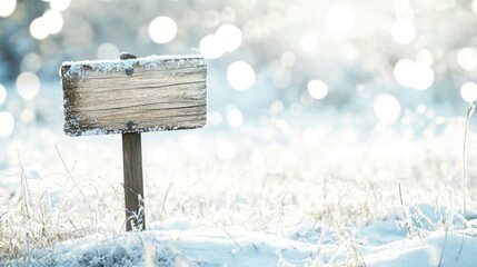 Fototapeta premium Winter landscape blanketed in snow, complemented by a wooden sign, creating a serene ambiance with beautiful bokeh effects, perfect for seasonal visuals and photo style copy space.