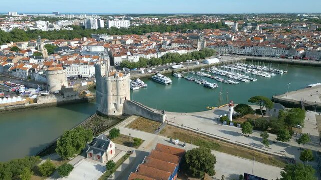 Approaching drone movement towards the Vieux port and Lantern towers, La Rochelle, France.