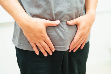 Hernia, Asian man stomach ache, abdominal pain and urology problem health.