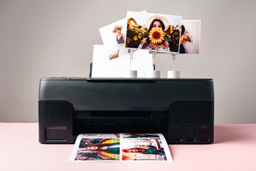 Modern laser printer printing color photos of women close up