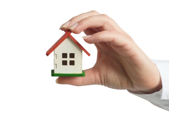 A female hand in a white shirt holding a small house