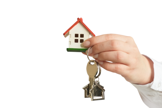 A female hand in a white shirt holding a small house and a key