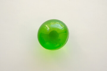 Green soft gel medicine pill capsule on white background
