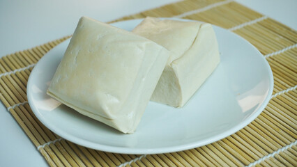Two blocks of white tofu on a white plate