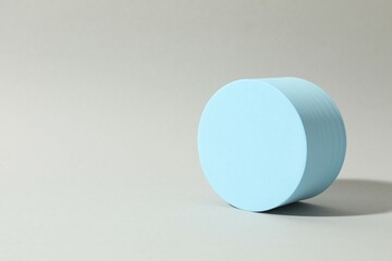 Props for product photography. Blue podium on a gray background