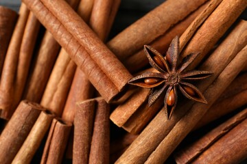 Aromatic cinnamon and anise stars on a wooden background