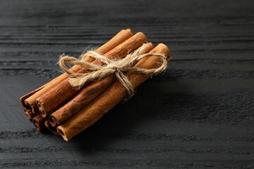 Aromatic cinnamon on a wooden background