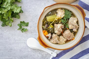 Pickled Lettuce Soup with Pork Rips in a white bowl
