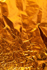 Seamless gold leaf background texture. Shiny golden yellow crumpled metallic foil repeat pattern. Modern abstract luxury gilded age wallpaper. Christmas glitter decoration backdrop. 3D rendering