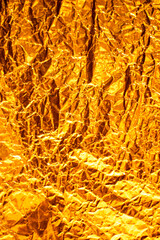 Seamless gold leaf background texture. Shiny golden yellow crumpled metallic foil repeat pattern. Modern abstract luxury gilded age wallpaper. Christmas glitter decoration backdrop. 3D rendering