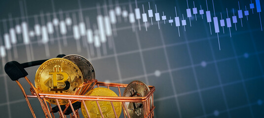 Bitcoin in mini shopping trolley with investment charts background. Concept for crypto currency buying and selling. Bitcoin background