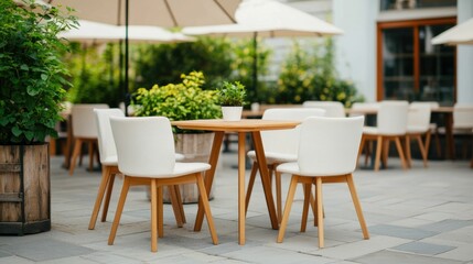 Obraz premium Trendy Minimalist Outdoor Cafe Setting with Cozy Seating Umbrellas and Lush Greenery Providing a Relaxing and Inviting Atmosphere for Dining Socializing and Leisure