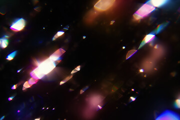 Prismatic light leaks with rainbow bokeh on dark background. Modern artistic design, abstract technology, digital effects.