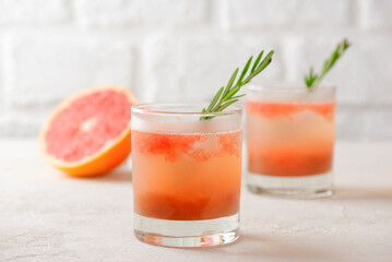 Grapefruit drink, tea, lemonade, cocktail with rosemary and ice. Healthy drink, sugar and alcohol free.