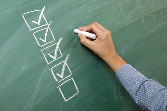 teacher write check box list on class board. Lesson and knowledge summary