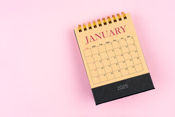 January 2025 desk calendar on pink color background, Position with copy space.