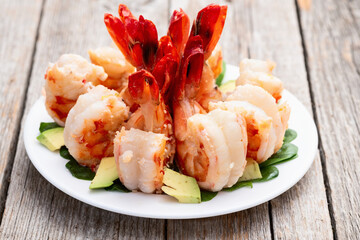 Salad with tiger shrimps , avocado and mango . Top view