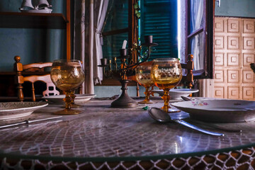 A beautifully set table adorned with plates, glasses, and candles on it