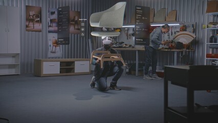 Modern workshop: Professional artisan or designer wearing VR headset assembles chair using extended...