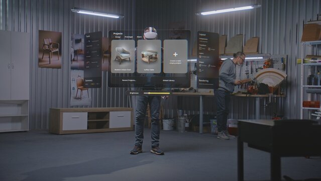 Modern workshop: Professional artisan or designer wearing VR headset assembles chair using extended reality and app with AI user interface. 3D graphics of holographic virtual furniture. VFX animation.