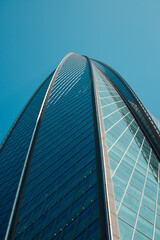 A Stunning Modern Skyscraper Perspective Set Against a Bright, Clear Blue Sky Background
