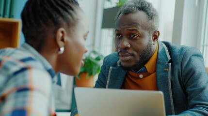 Fototapeta premium Young manager collaborates with experienced colleague on various projects.