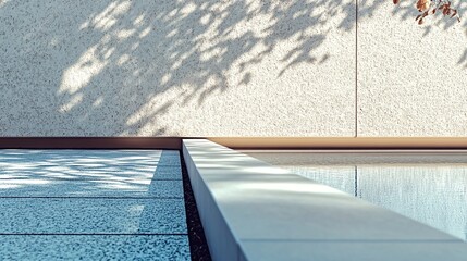 Obraz premium Minimalist poolside patio with textured wall and dappled sunlight.