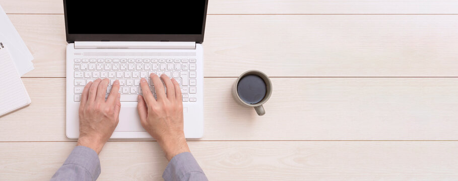 A ｍan using a laptop PC. ノートパソコンを使う男性。