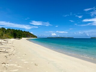 Beach travel vacation tropical paradise getaway on banggai island with idyllic pristine ocean crystal clear turquoise water lagoon. Pefect honeymoon destination background.