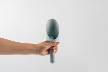 Garden tools with blue grips and hand on a white background