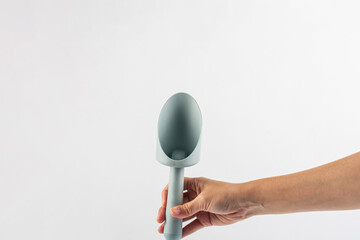 Garden tools with blue grips and hand on a white background